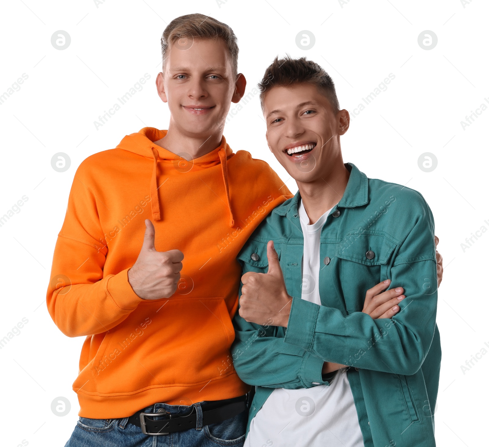 Photo of Two young brothers showing thumbs up on white background