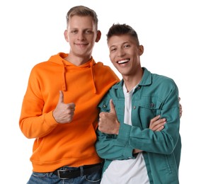 Two young brothers showing thumbs up on white background