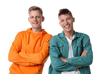 Photo of Two happy brothers posing with crossed arms on white background