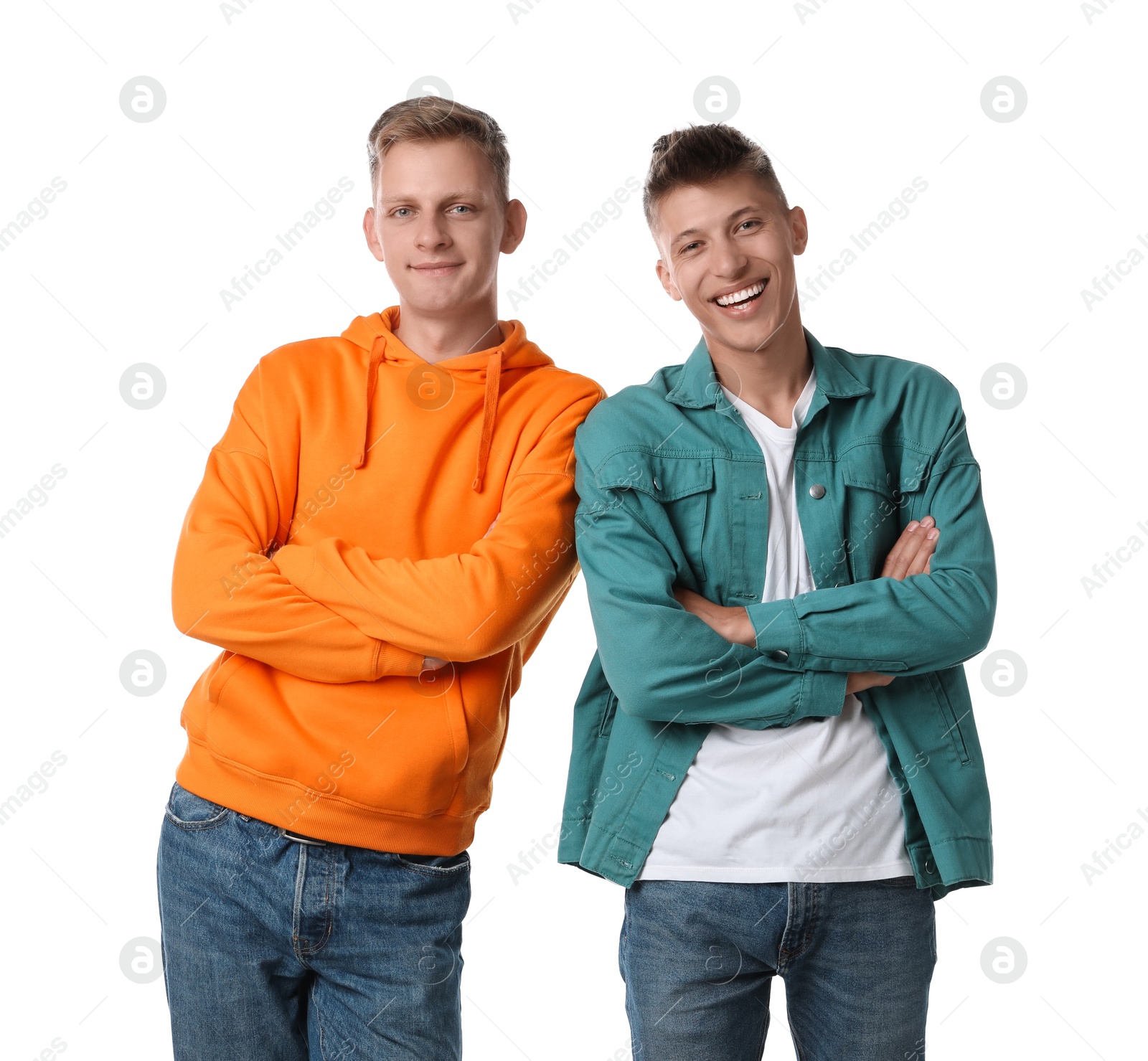 Photo of Two happy brothers posing with crossed arms on white background