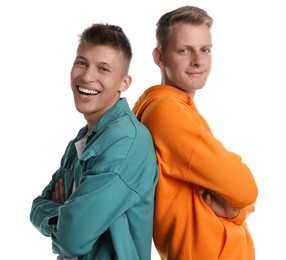 Two happy brothers posing with crossed arms on white background