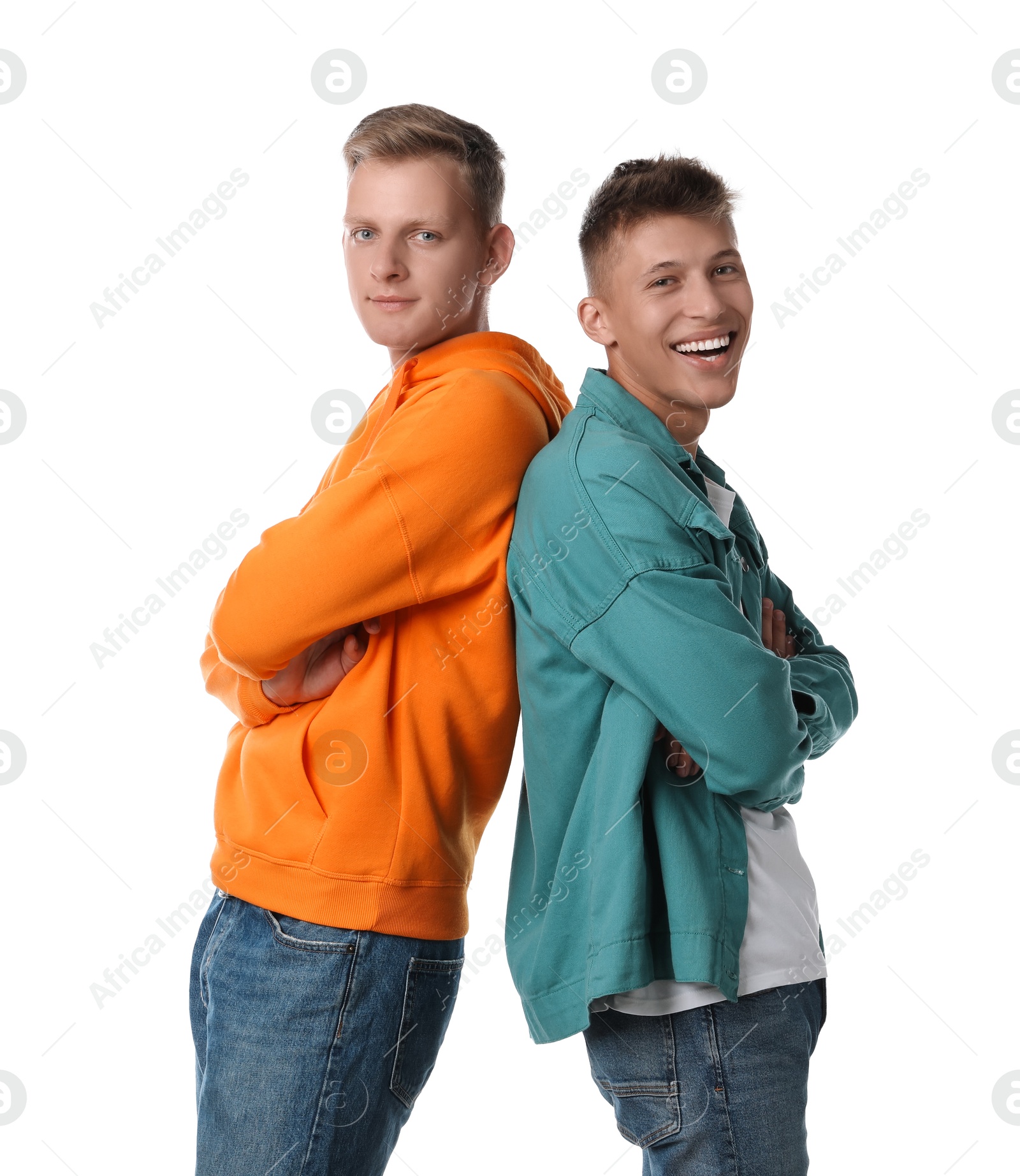 Photo of Two happy brothers posing with crossed arms on white background