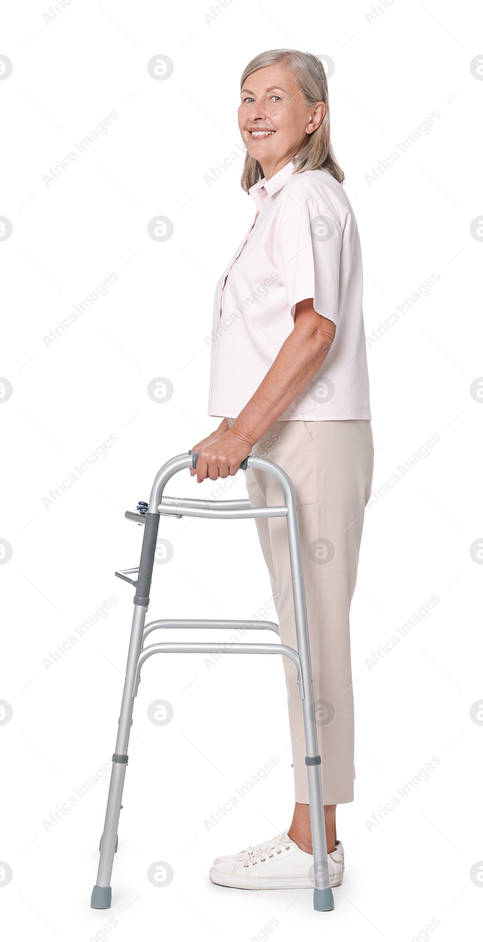 Photo of Senior woman using walking frame on white background