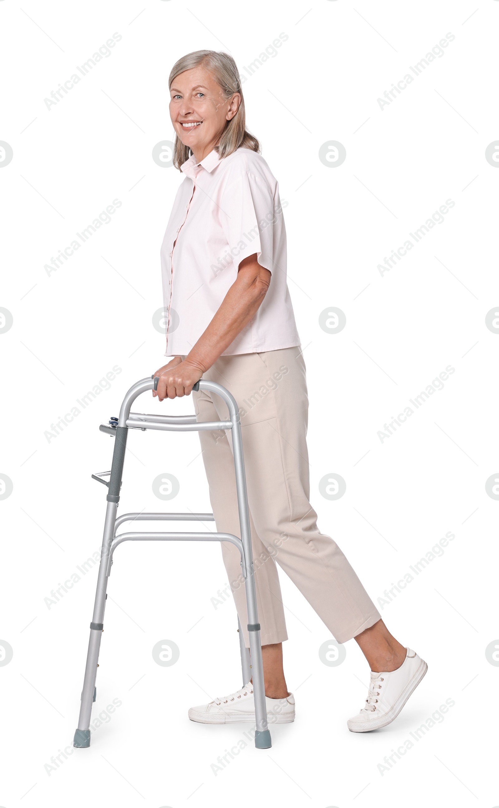 Photo of Senior woman using walking frame on white background