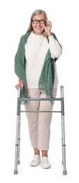 Senior woman using walking frame on white background