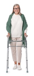 Senior woman using walking frame on white background