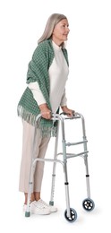 Senior woman using walking frame on white background