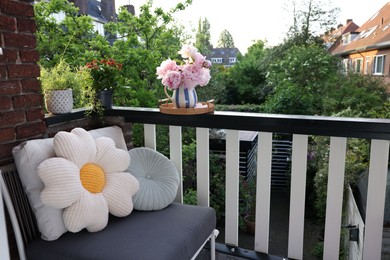 Photo of Different plants on railings and chair at cozy balcony outdoors