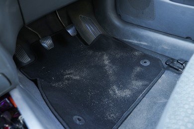 Photo of Black soft car floor mat in auto