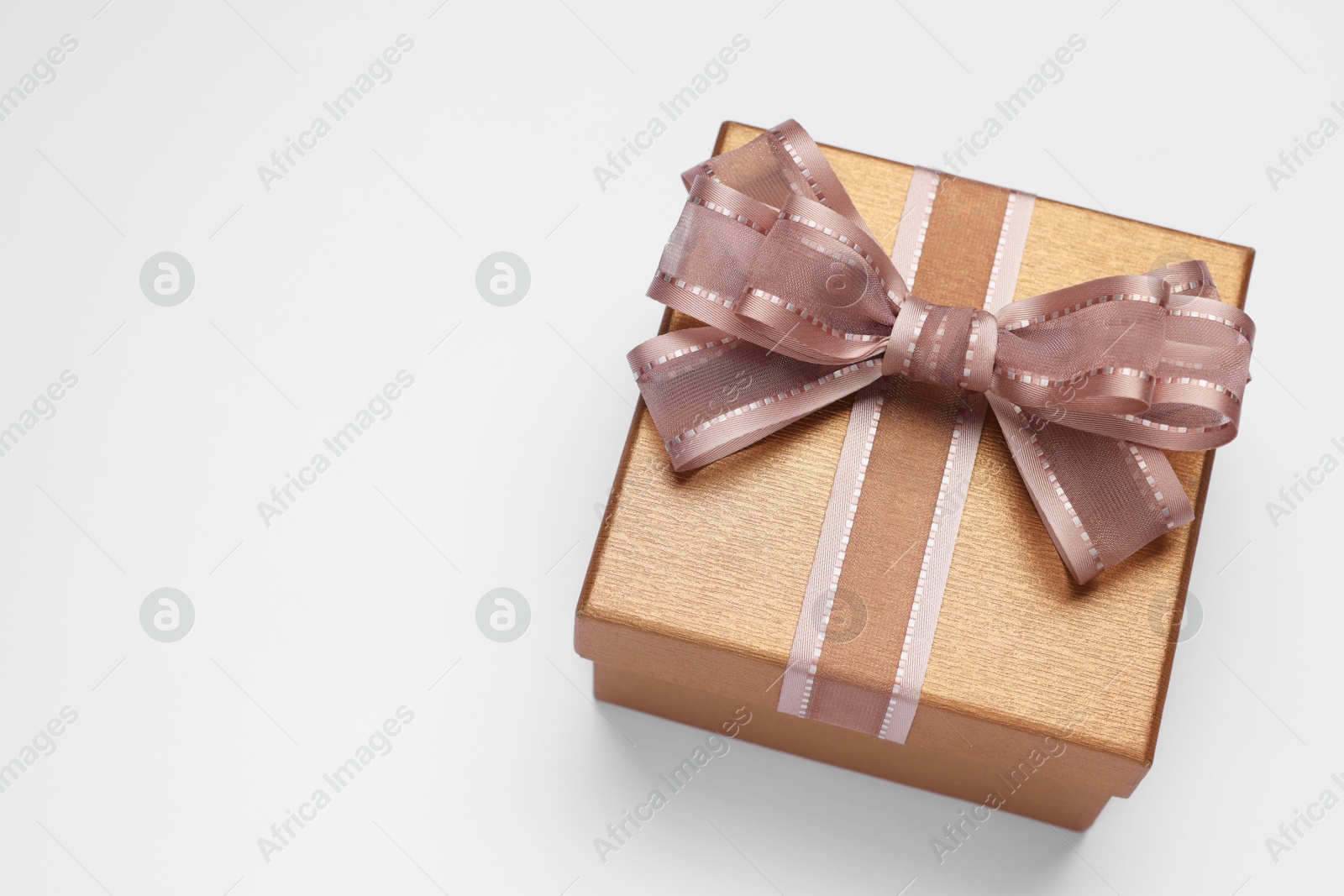 Photo of Gift box with bow on light grey background, above view. Space for text