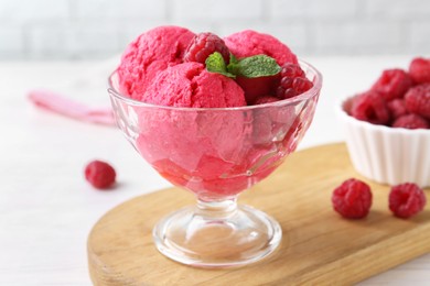 Delicious raspberry sorbet, mint and fresh berries on white wooden table, closeup