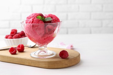 Photo of Delicious raspberry sorbet, mint and fresh berries on white wooden table, space for text