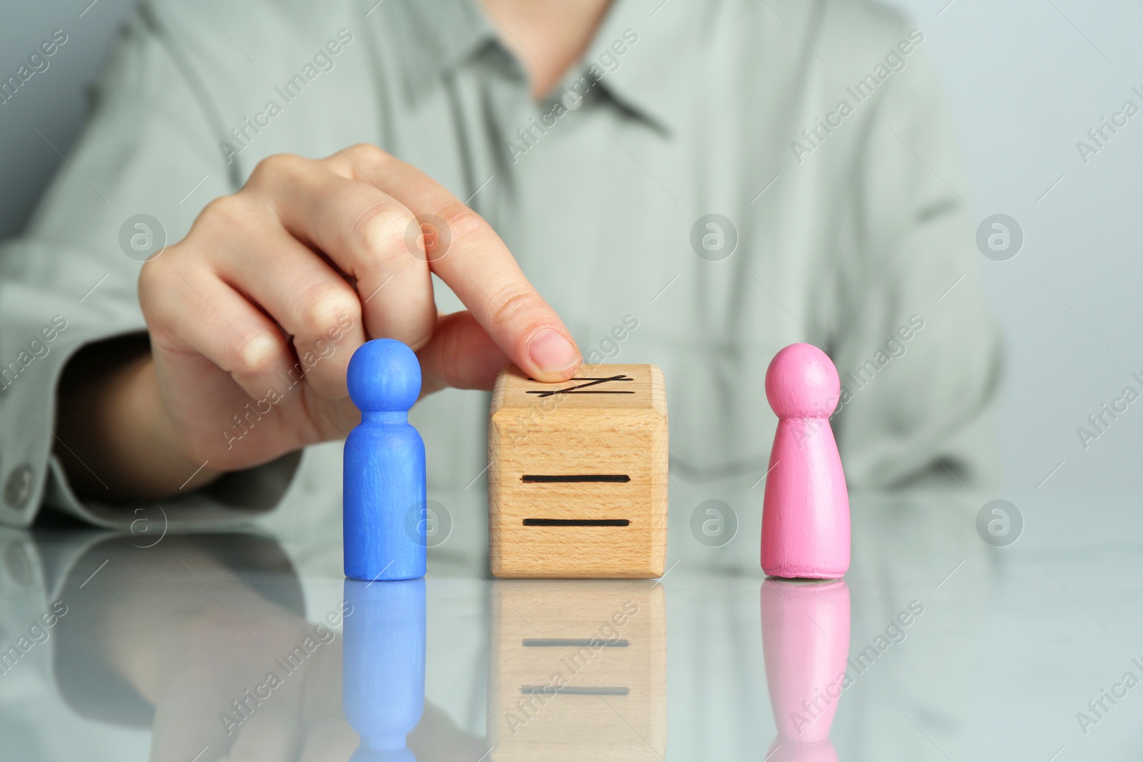 Photo of Gender equality concept. Woman with male and female figures at grey table, closeup