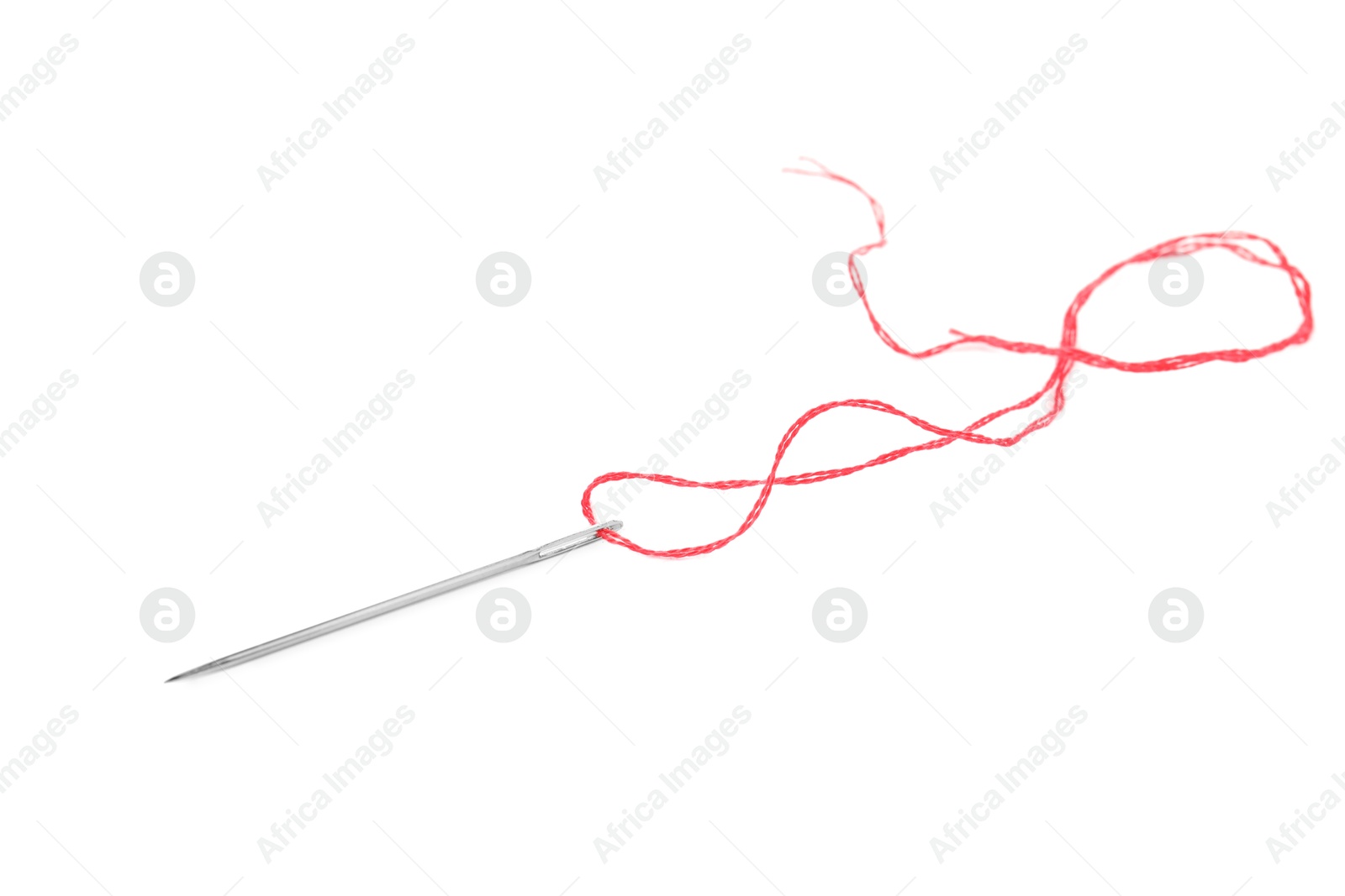 Photo of Sewing needle with red thread isolated on white