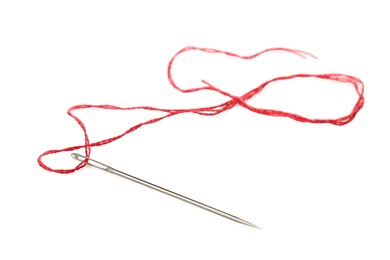 Photo of Sewing needle with red thread isolated on white