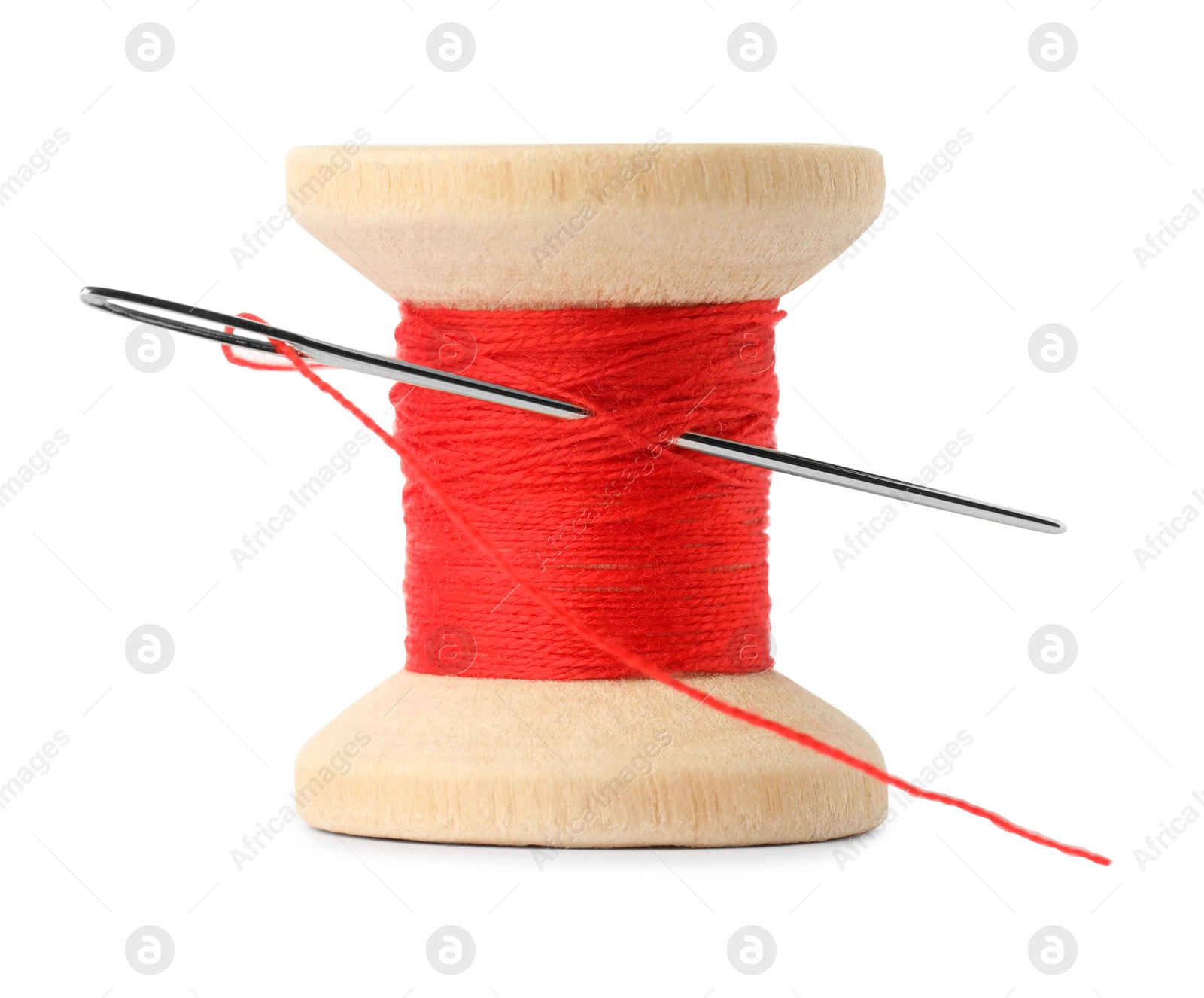 Photo of Spool of red sewing thread with needle isolated on white