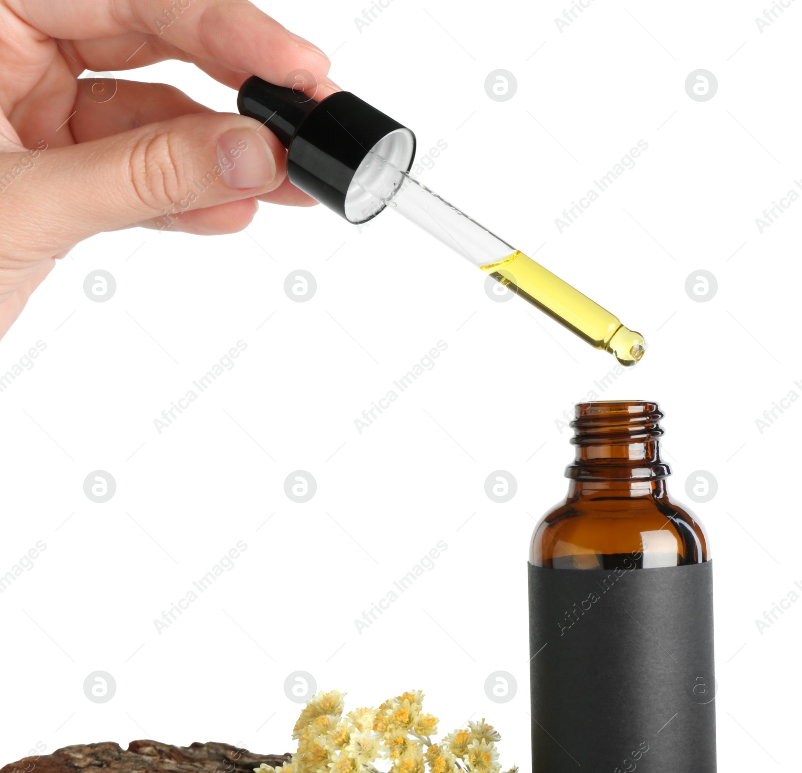 Photo of Woman dripping tincture from pipette into bottle against white background, closeup