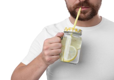 Photo of Man drinking water with lemon on white background, closeup