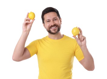 Happy man holding lemons on white background