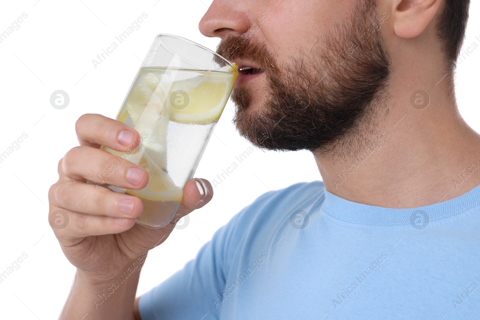 Photo of Man drinking water with lemon on white background, closeup