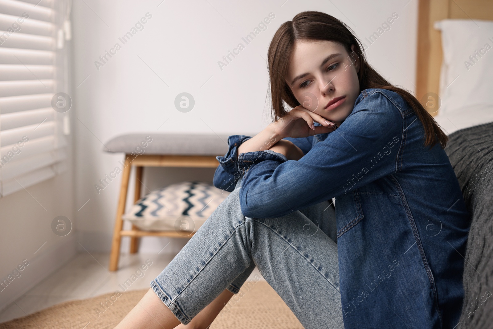 Photo of Loneliness concept. Sad teenage girl on floor at home