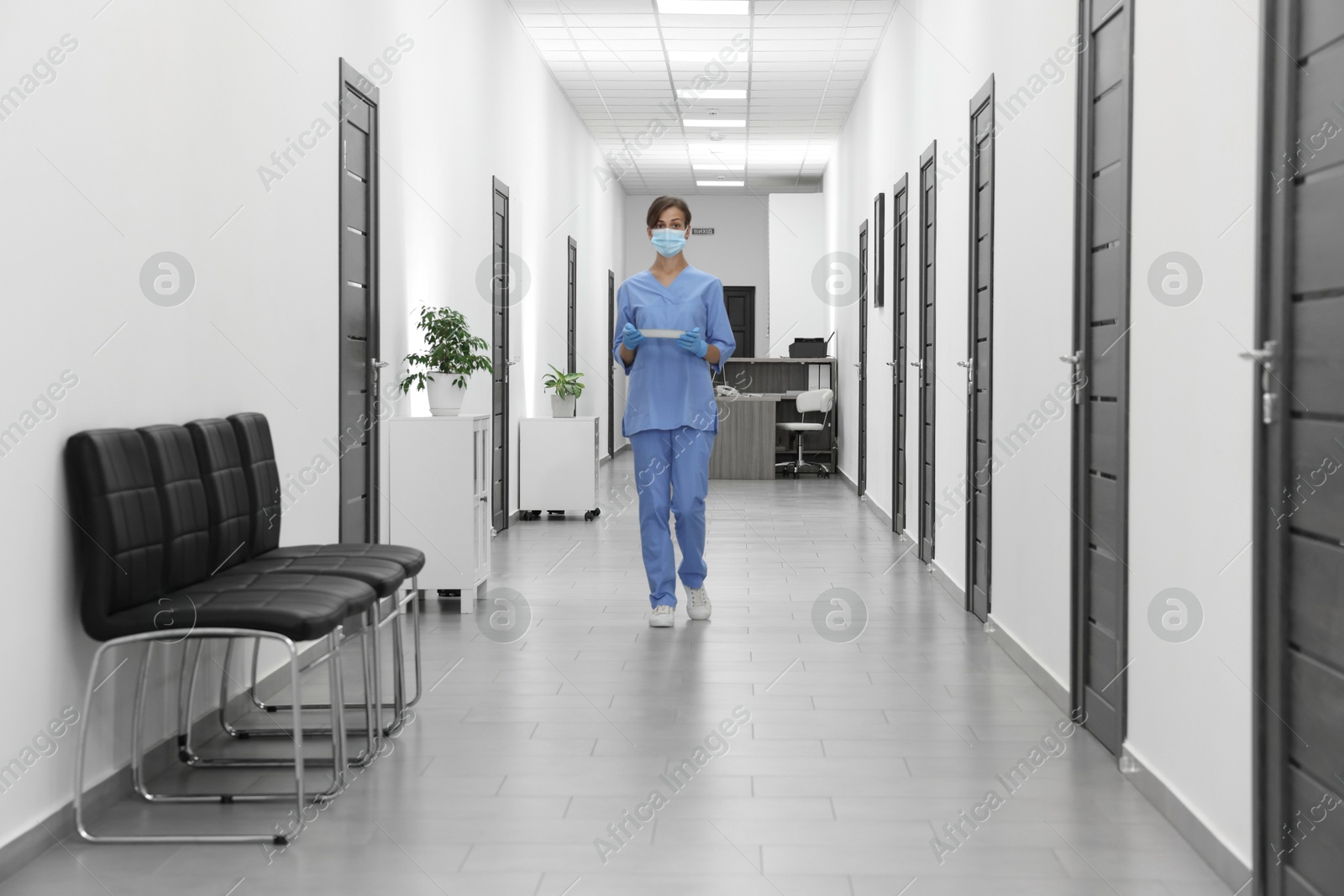 Photo of Nurse in uniform walking in hospital hallway