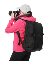 Photo of Photographer with backpack and camera taking picture on white background