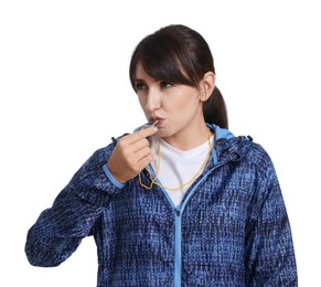 Young woman blowing whistle on white background