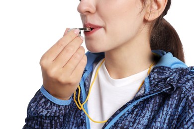 Woman blowing whistle on white background, closeup