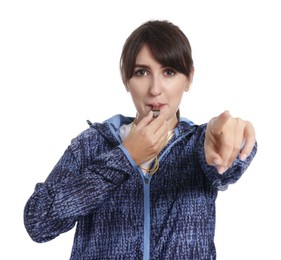 Young woman blowing whistle on white background