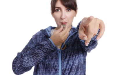 Woman blowing whistle on white background, selective focus