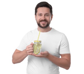 Happy man holding mason jar of water with lemon on white background