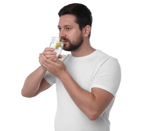 Handsome man drinking water with lemon on white background