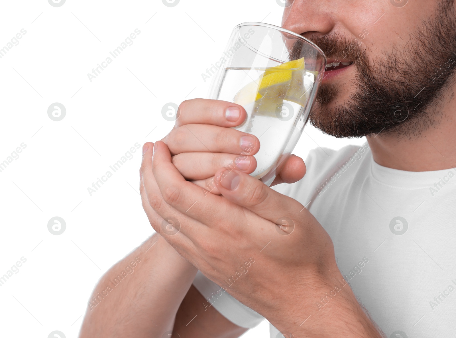 Photo of Man drinking water with lemon on white background, closeup