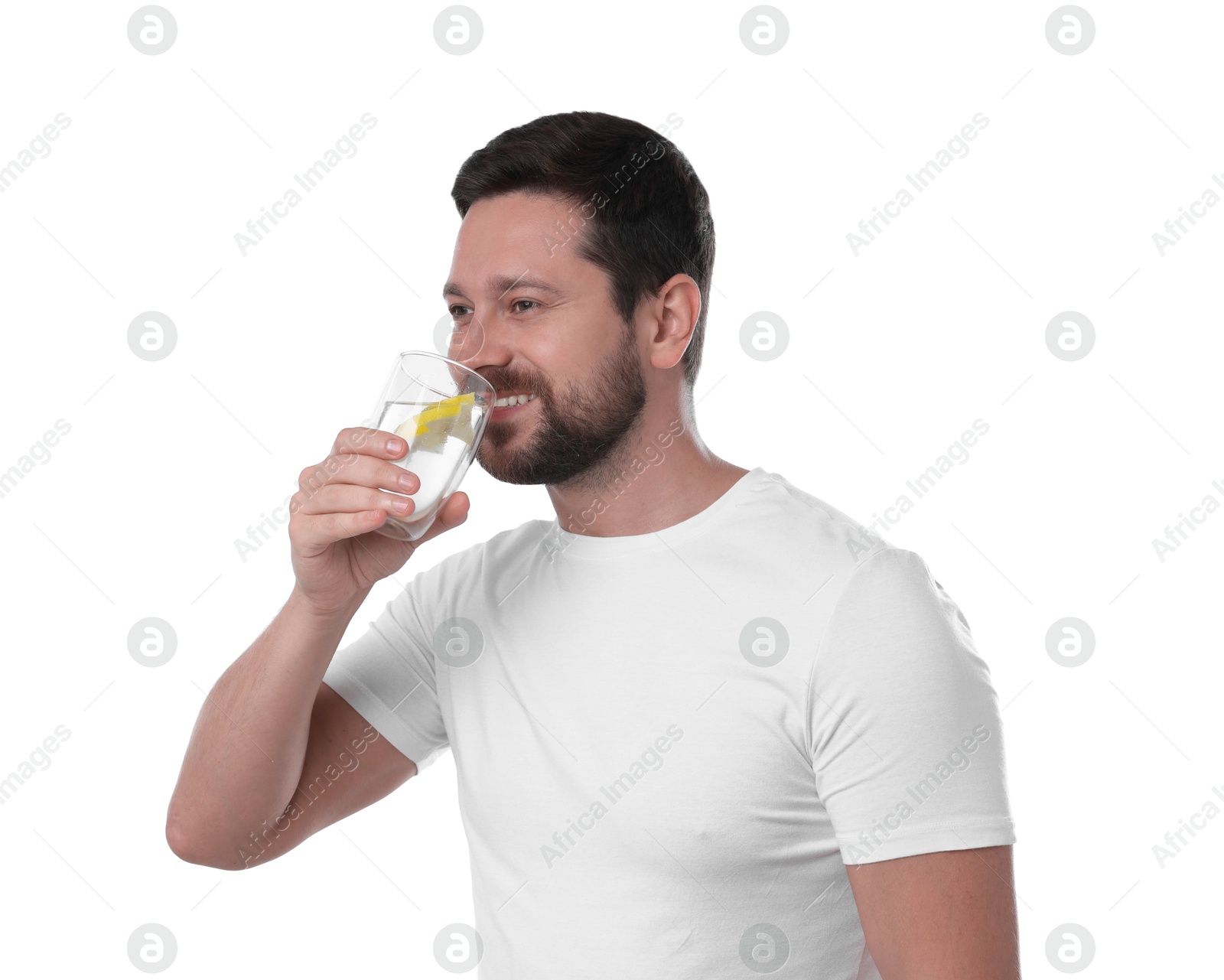 Photo of Happy man drinking water with lemon on white background