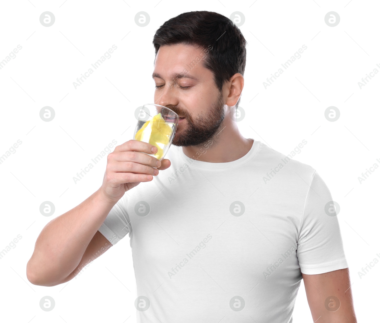 Photo of Handsome man drinking water with lemon on white background