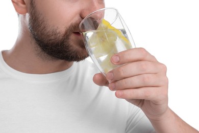 Man drinking water with lemon on white background, closeup