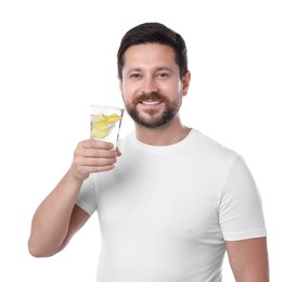 Photo of Happy man holding glass of water with lemon on white background