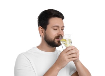 Handsome man drinking water with lemon on white background