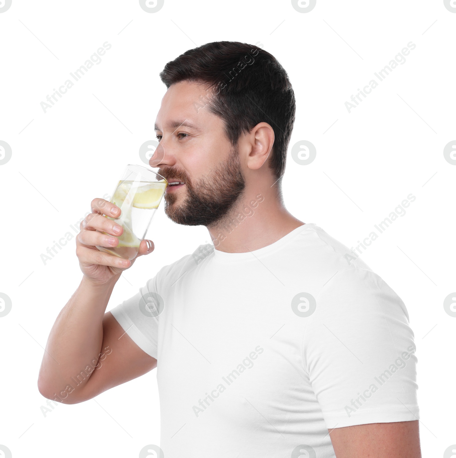 Photo of Handsome man drinking water with lemon on white background