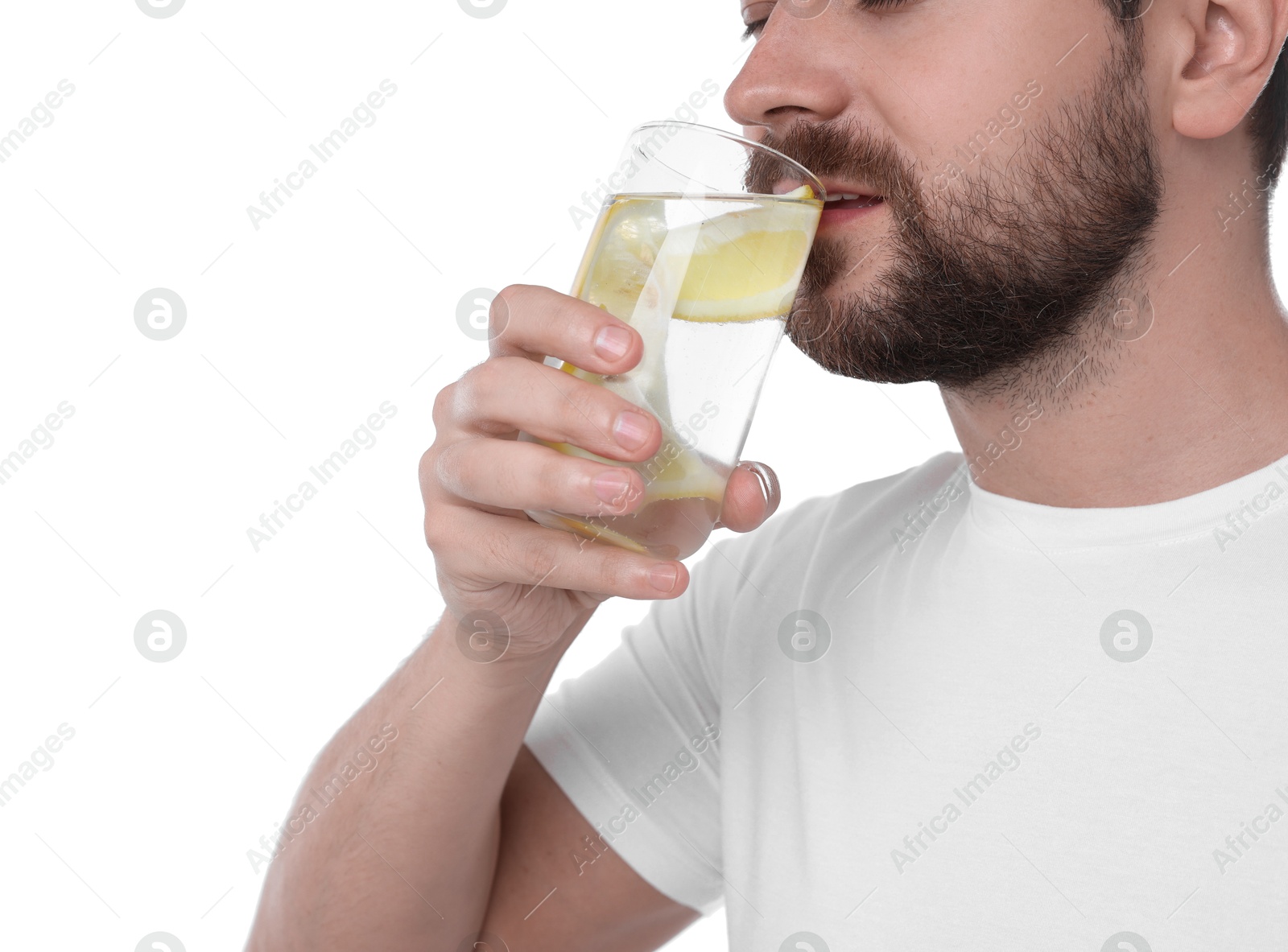 Photo of Man drinking water with lemon on white background, closeup