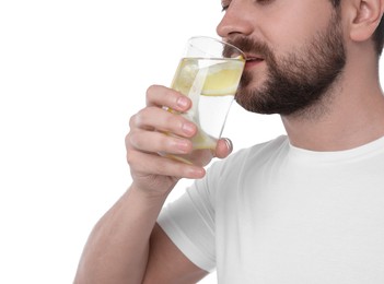 Photo of Man drinking water with lemon on white background, closeup