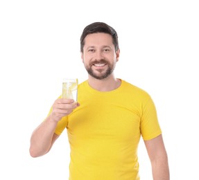 Photo of Happy man holding glass of water with lemon on white background