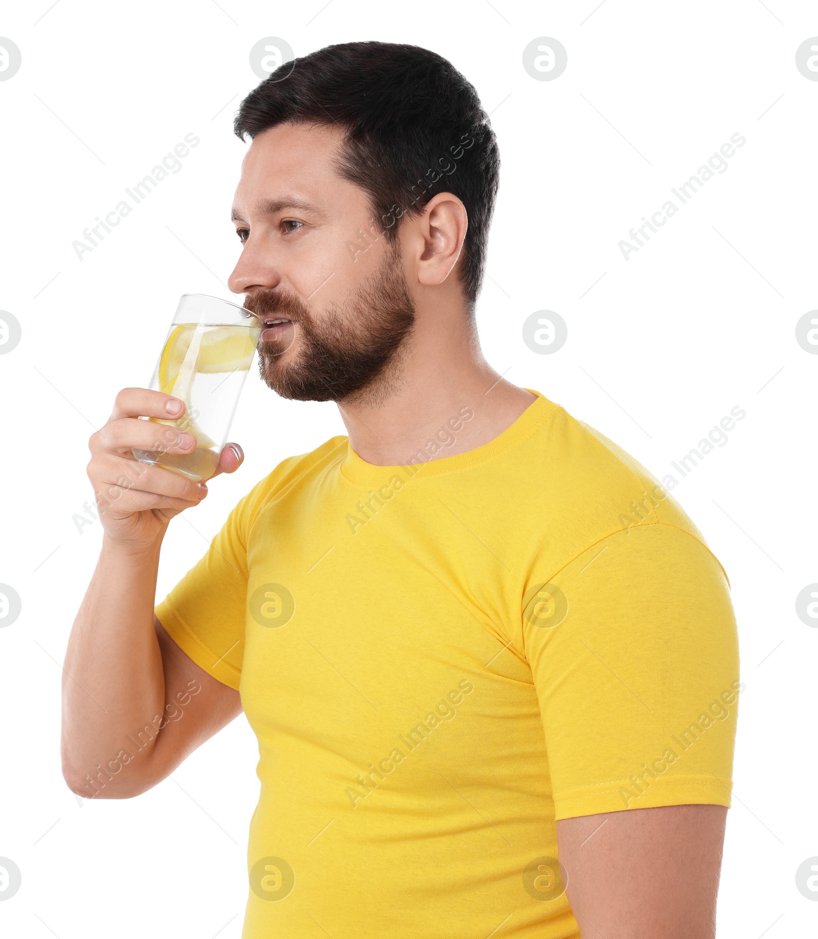 Photo of Handsome man drinking water with lemon on white background