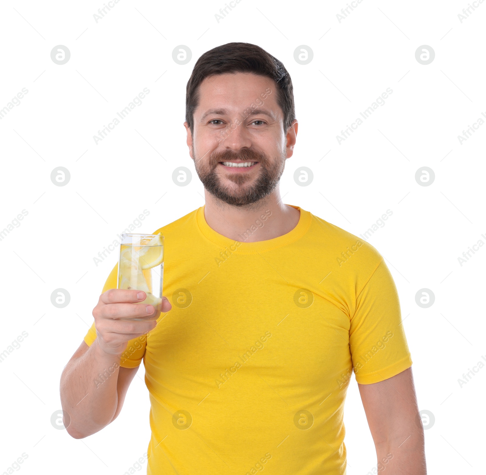 Photo of Happy man holding glass of water with lemon on white background