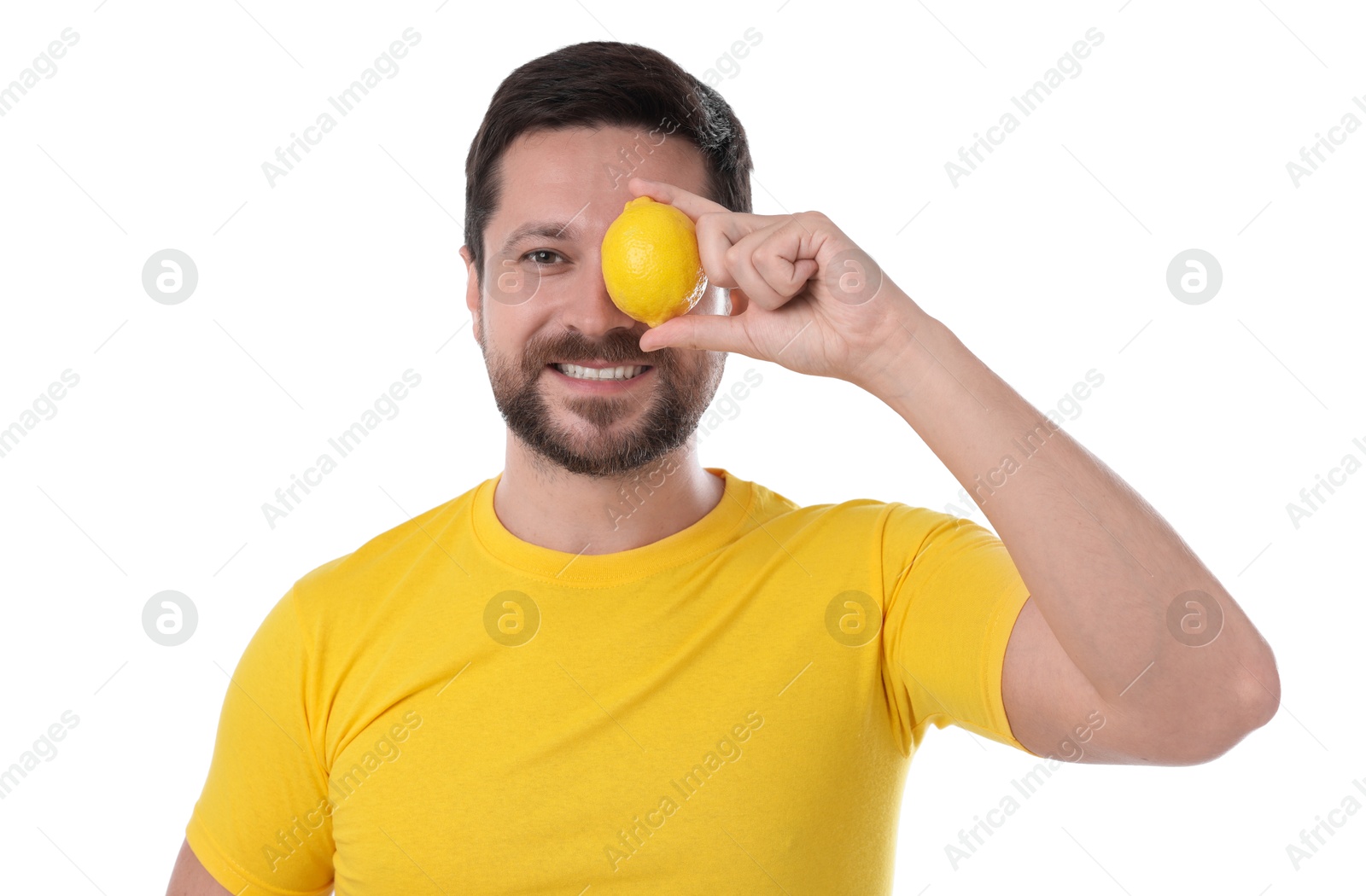 Photo of Happy man covering eye with lemon on white background