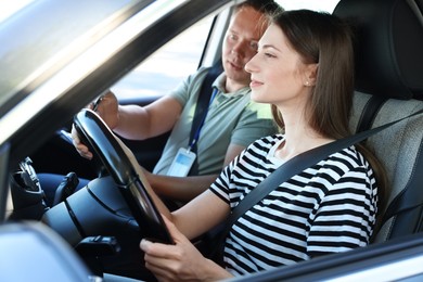 Photo of Driving school. Student passing driving test with examiner in car