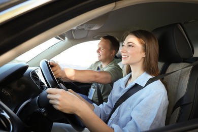 Driving school. Student passing driving test with examiner in car