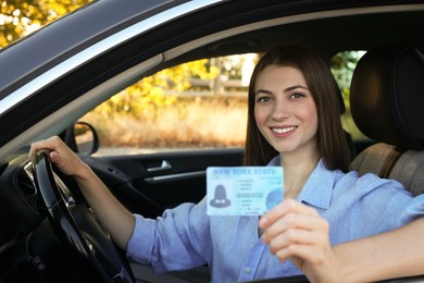 Driving school. Woman with driving license in car