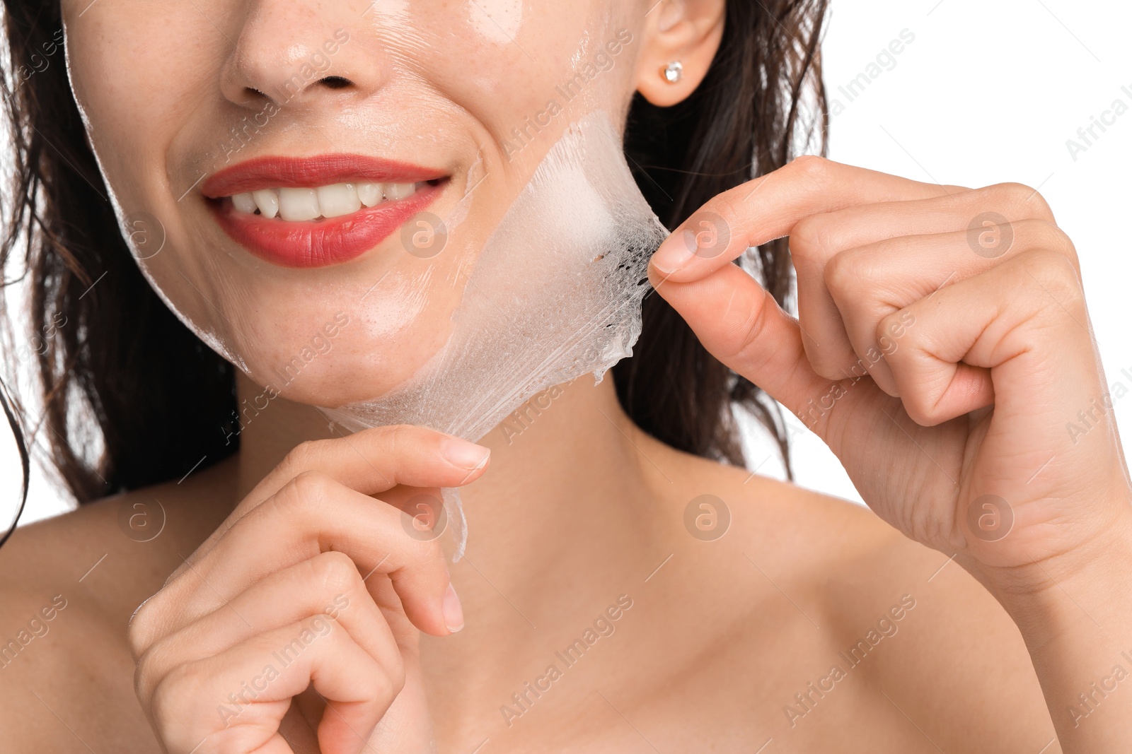 Photo of Smiling woman peeling off face mask on white background, closeup